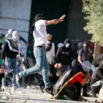 Arab rioters hurl rocks